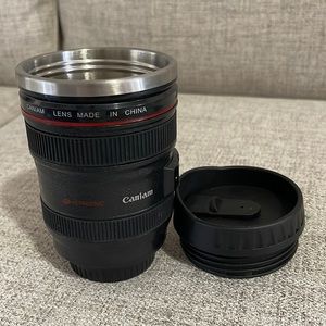 A DSLR camera lens Coffee Mug with details like a focus ring and grip.